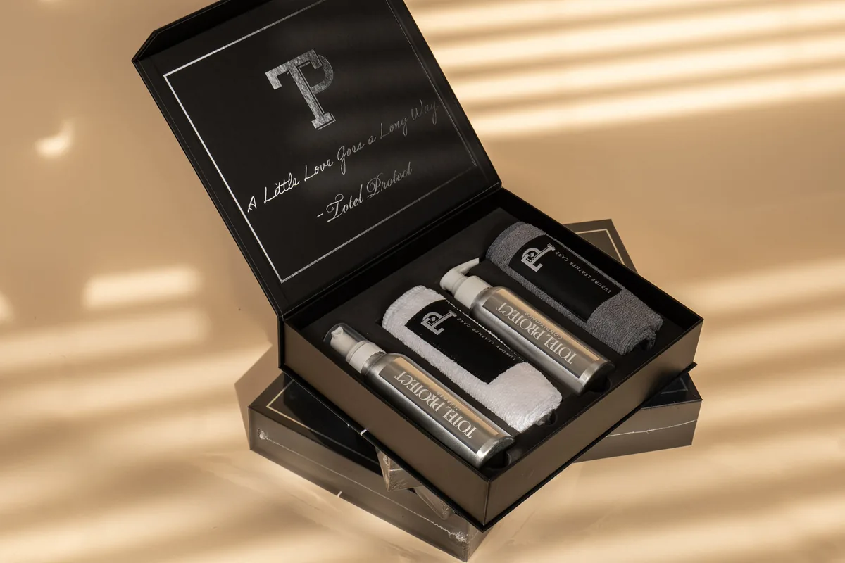 The Signature Leather Interior Kit open, with leather cleaner, leather conditioner and two microfibre cloths