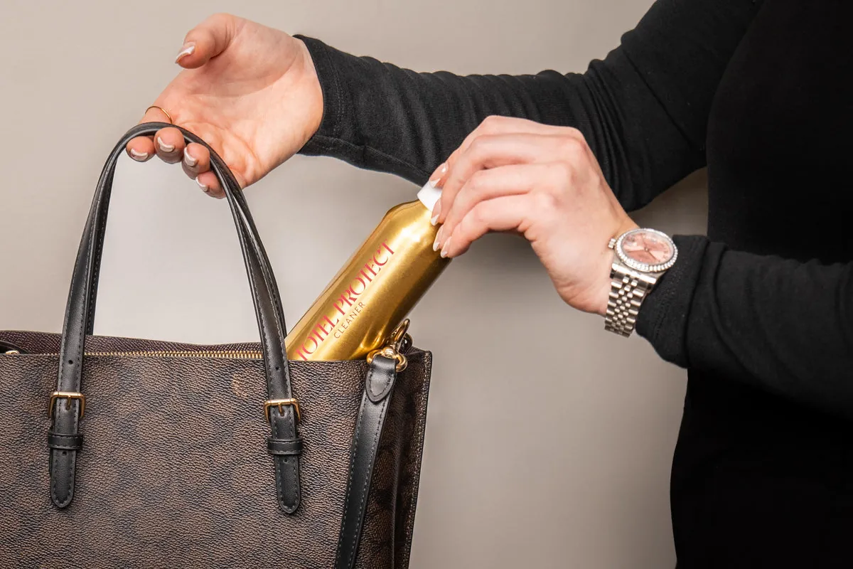 Leather cleaner being applied gently to a brown finished leather handbag