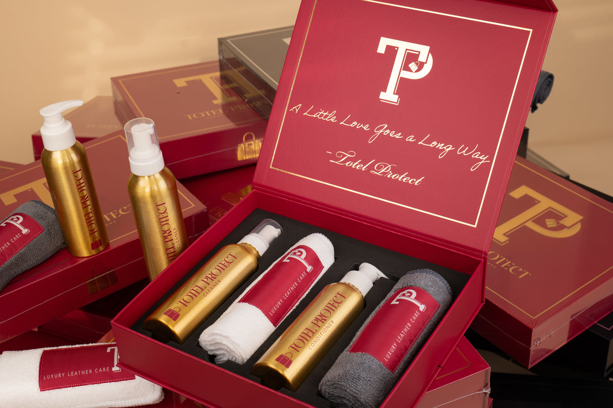 Luxe Handbag Care Kit open box with leather cleaner, conditioner and two microfibre cloths